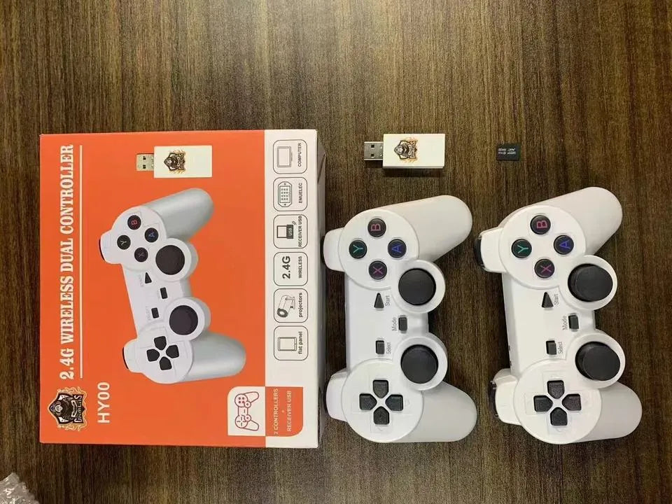 Two white gaming controllers with a box labeled '2.4G Wireless Dual Controller HY00' on a wooden surface.